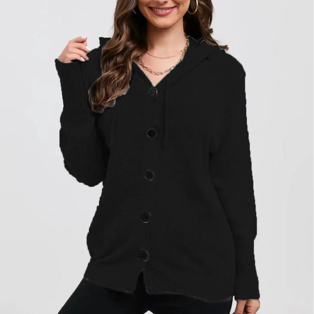 Woman wearing a thick, loose-fit hooded cardigan sweater in a solid colour with a 3D textured pattern.