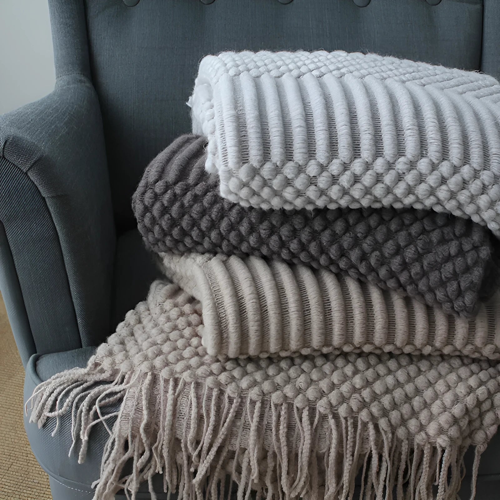 Small polyester nap blanket in dark grey, khaki, or light grey colours showing 127x170cm dimensions