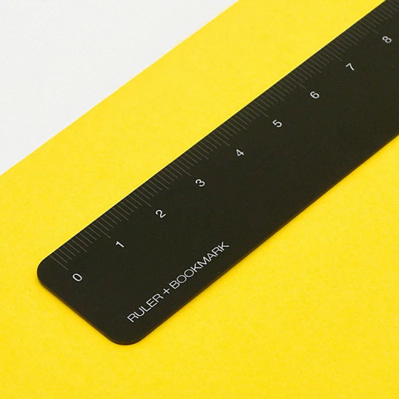 RUMA black aluminium ruler bookmark showing 15cm laser-engraved scale