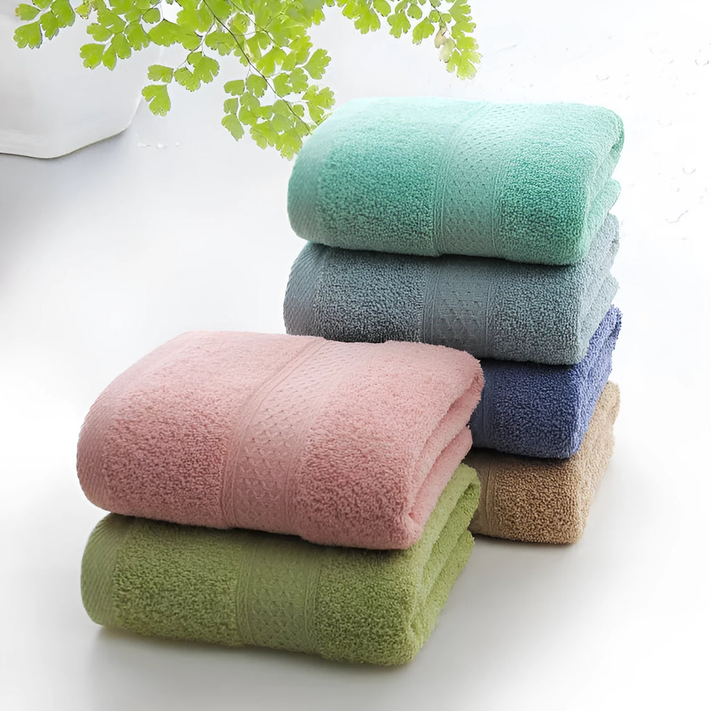 Thickened cotton blend bath and beach towel shown in multiple colour options including green, blue, and pink variations.