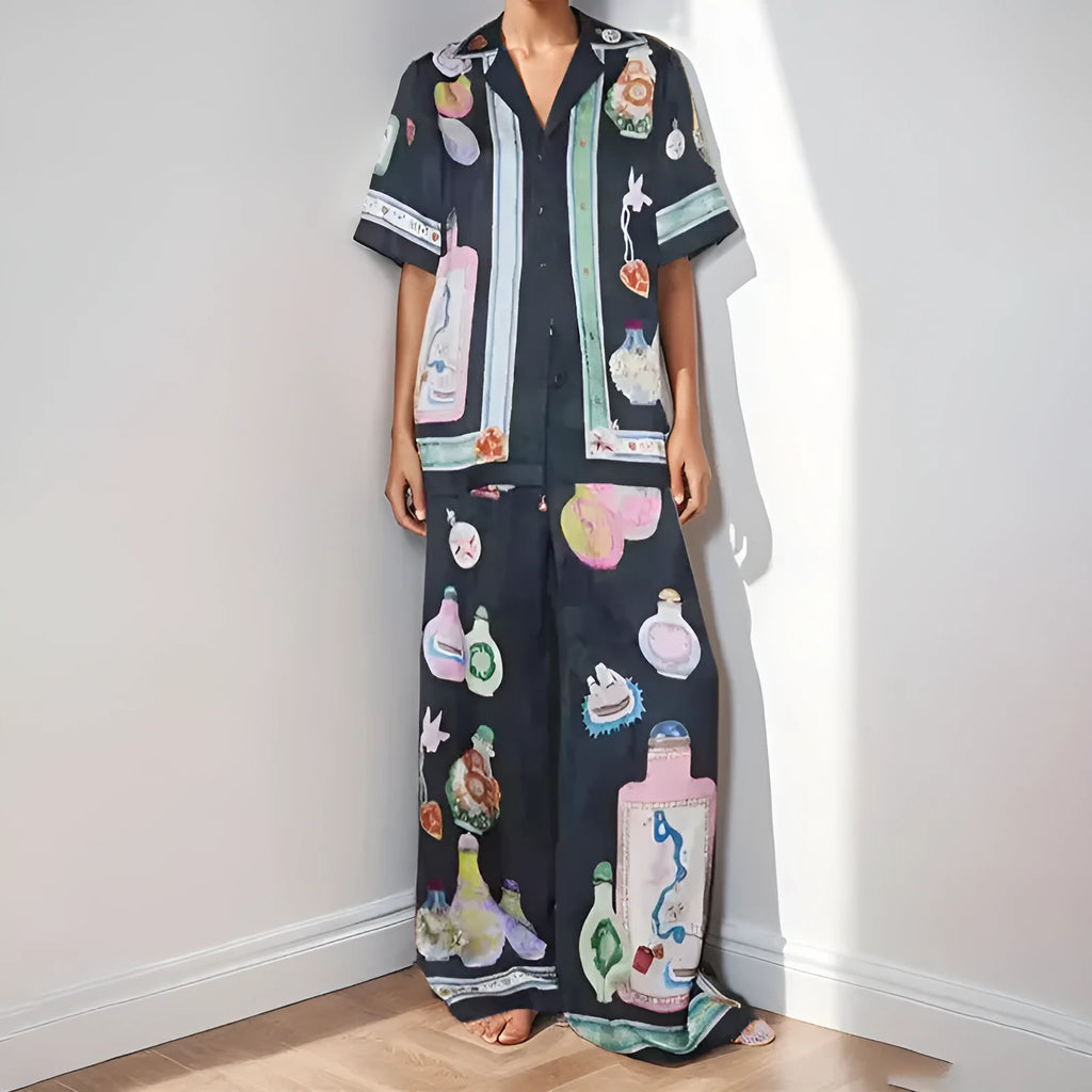 Women's black polyester co-ord set with cartoon animation print showing cardigan and trousers