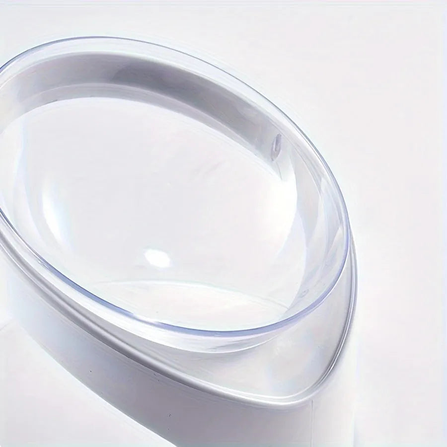 Clear plastic tilted cat food bowl for ergonomic feeding and neck protection