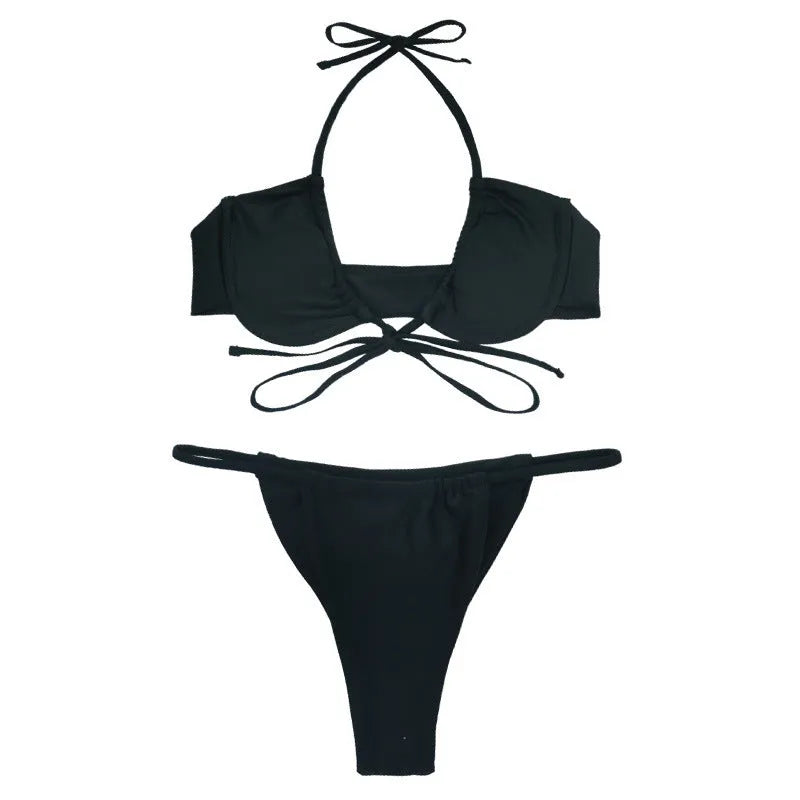 Women's black and mint green split design bikini swimsuit set on a white background.