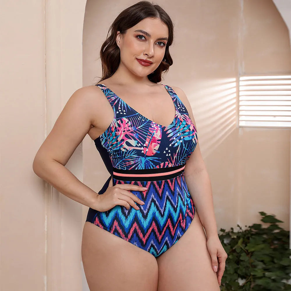 Women's striped vest one-piece swimsuit with spaghetti straps and floral print on blue background.