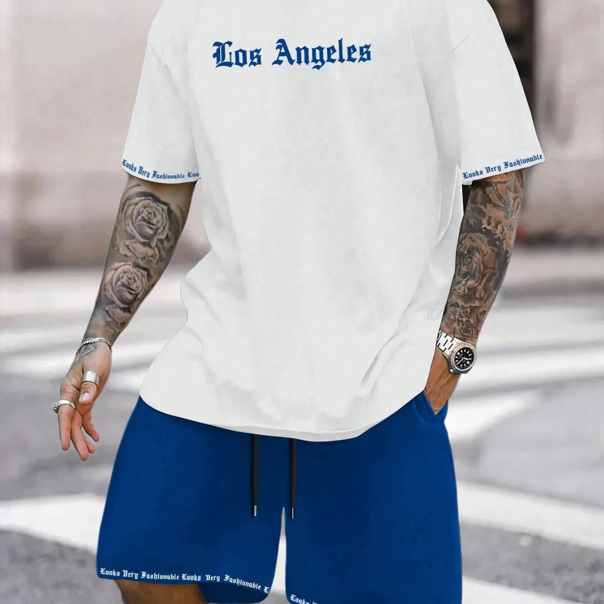 Man wearing a printed short-sleeve top and matching quick-dry sport shorts in a grey colour.