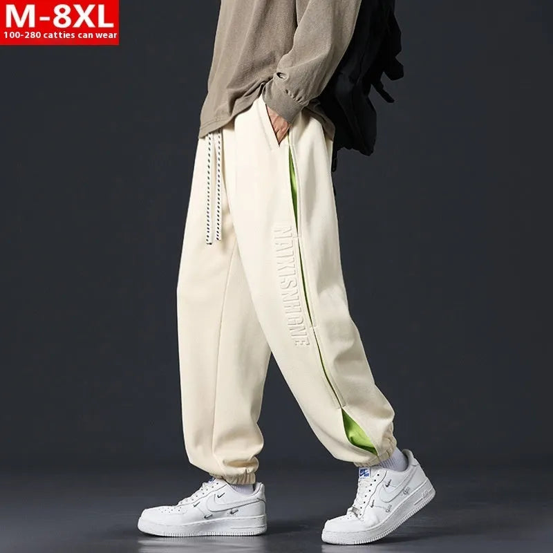 Men's loose-fit cotton trousers with stitching print detail and a banded ankle cuff.