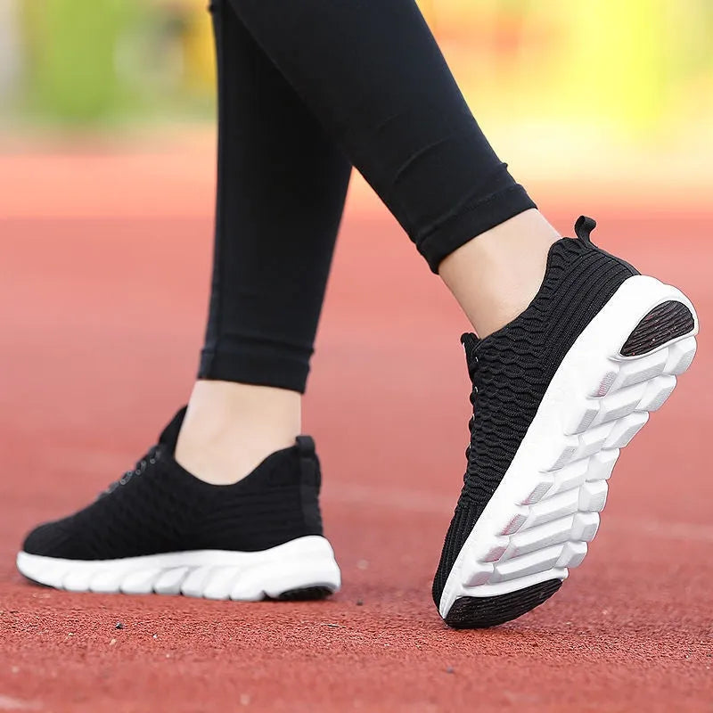 Women's running shoes with fly weaving upper in black, pink or white colours showing breathable construction