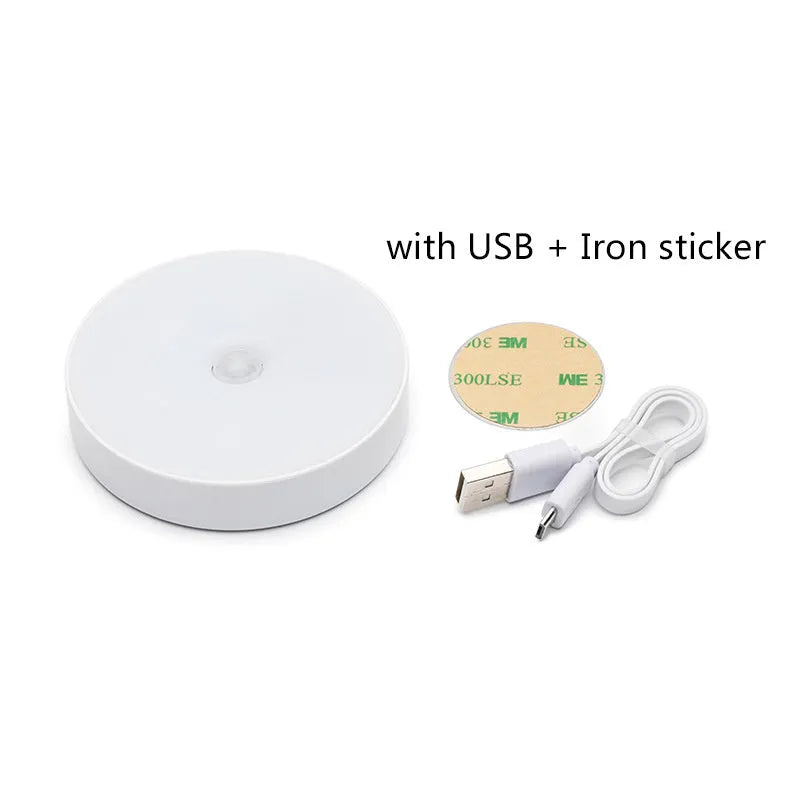 White circular motion sensor night light with USB charging port and adhesive backing