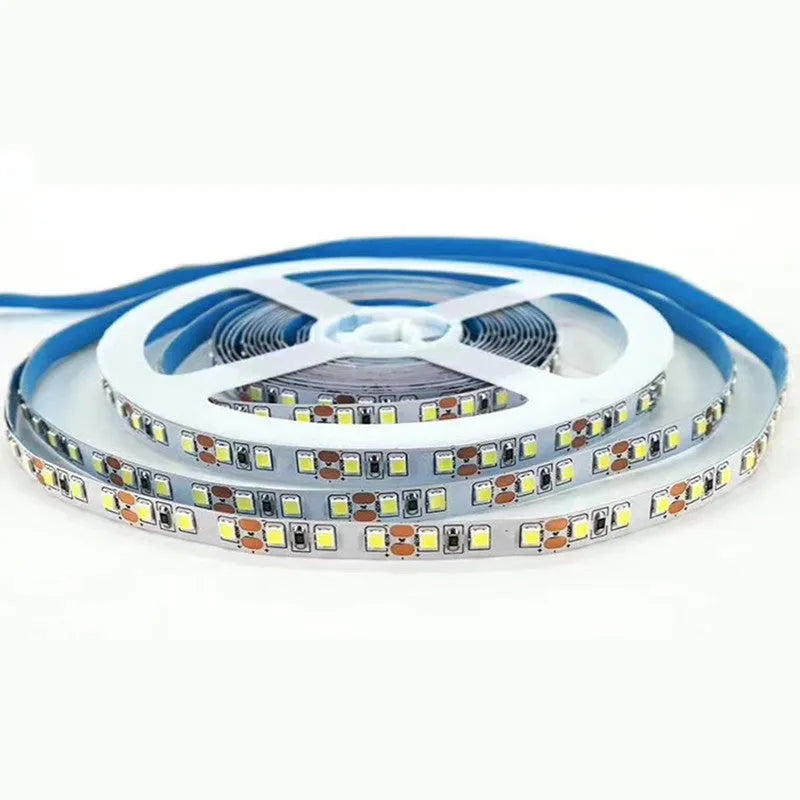Close-up of a white flexible LED light strip showing dense 2835 LEDs, mounted on a retail shelf edge.
