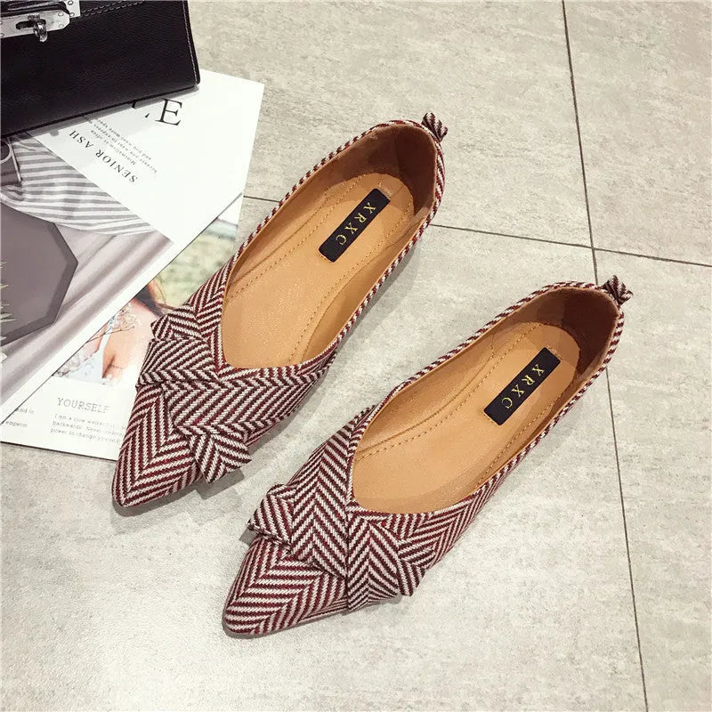 Women's black pointed toe flat shoes with a shallow mouth and cotton upper.