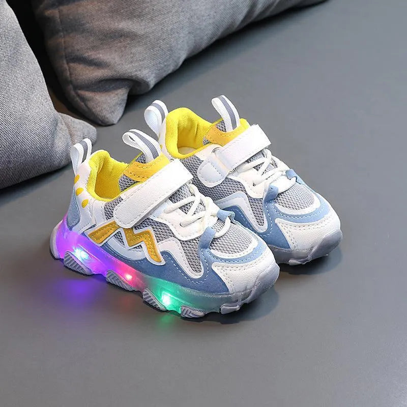 Children's bright sports sneakers with mesh panels and Velcro straps in black, pink, and grey.