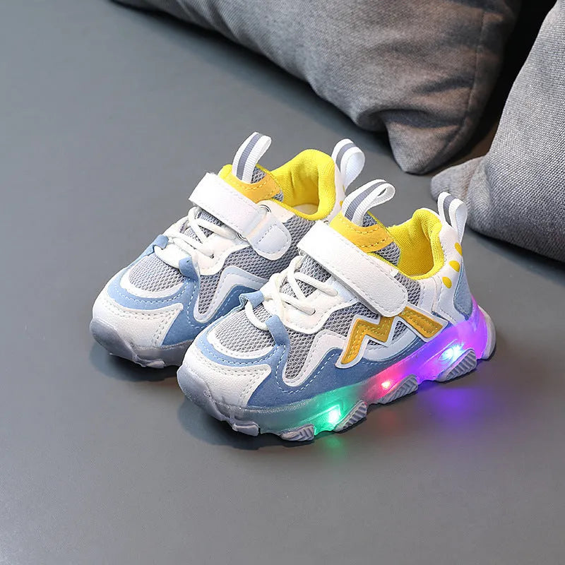 Children's bright sports sneakers with mesh panels and Velcro straps in black, pink, and grey.