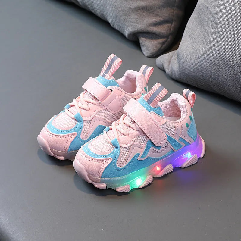 Children's bright sports sneakers with mesh panels and Velcro straps in black, pink, and grey.