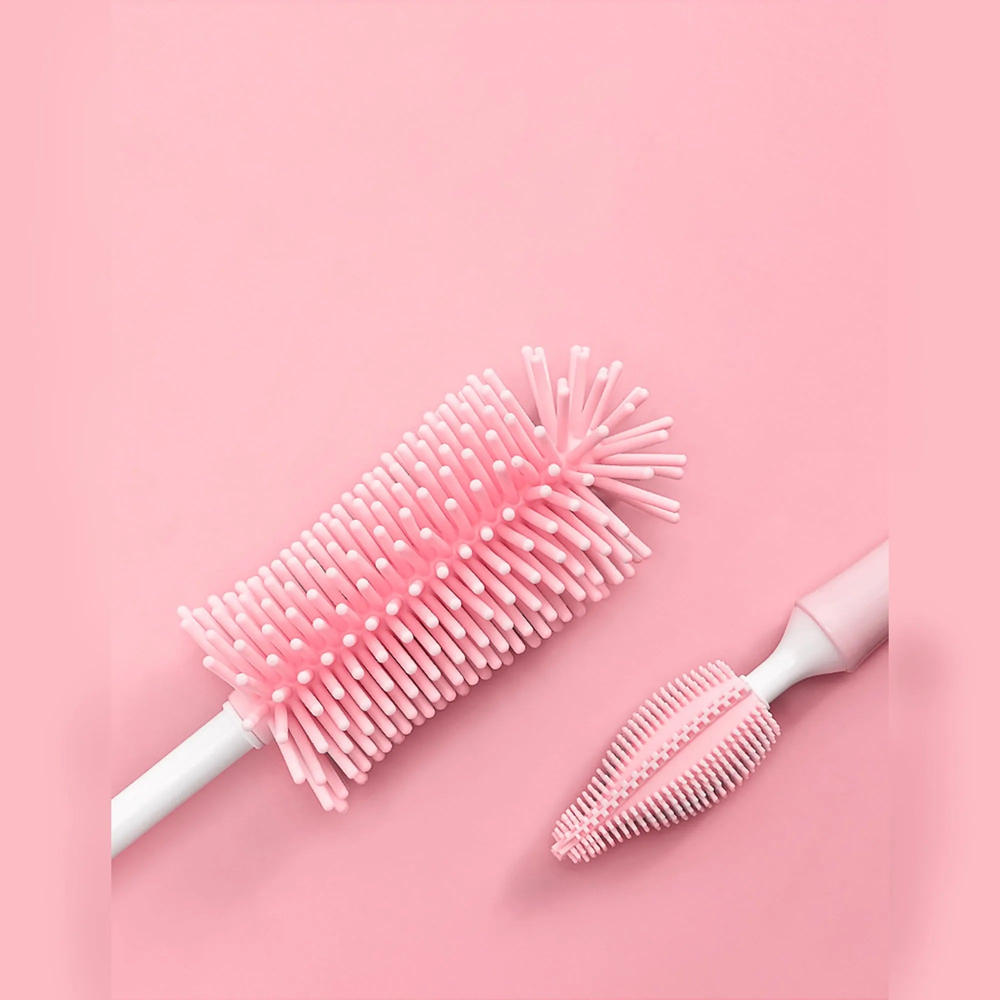 Pink, blue, and yellow silicone baby bottle brush sets with a straw cleaning brush.