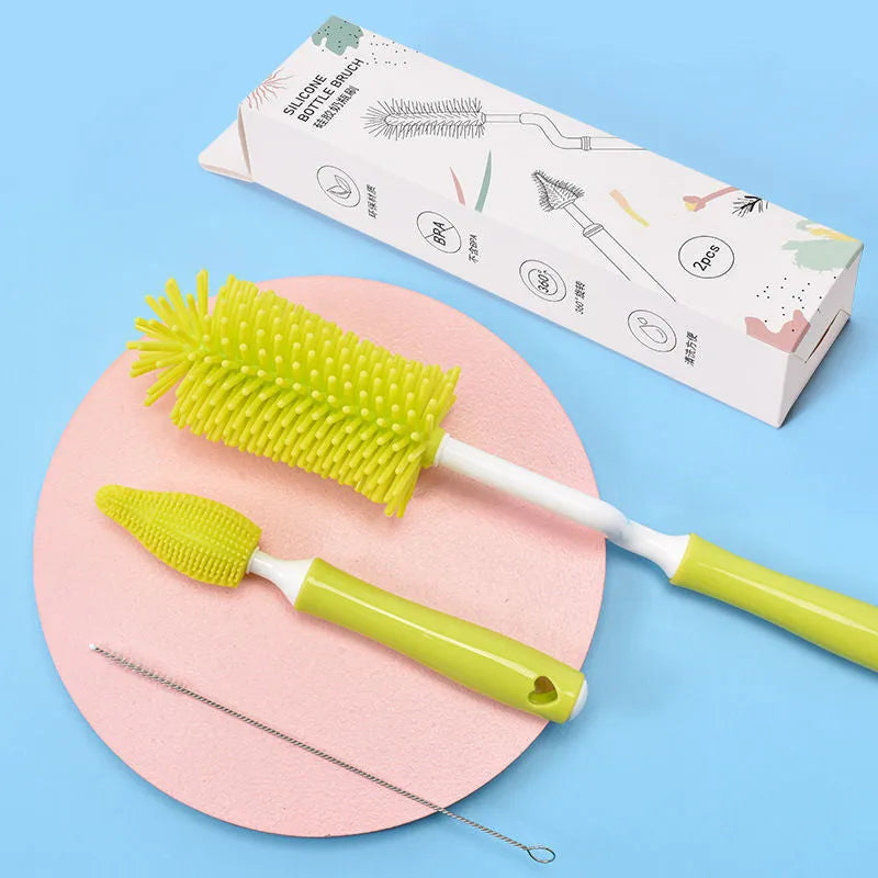 Pink, blue, and yellow silicone baby bottle brush sets with a straw cleaning brush.