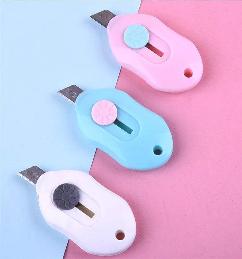 Cartoon art knife with plastic and metal construction for manual craft cutting
