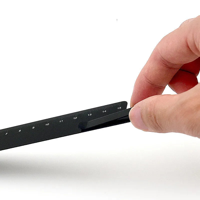 RUMA black aluminium ruler bookmark showing 15cm laser-engraved scale