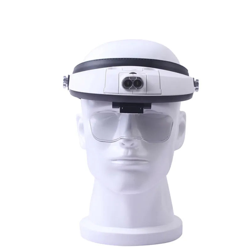 LED headband magnifier with adjustable strap and five acrylic lenses on a table