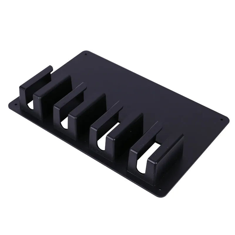 Black plastic wall-mounted rack holding four hair clippers