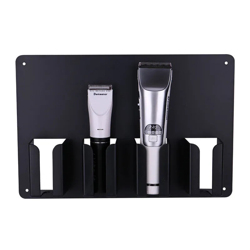 Black plastic wall-mounted rack holding four hair clippers