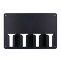 Black plastic wall-mounted rack holding four hair clippers