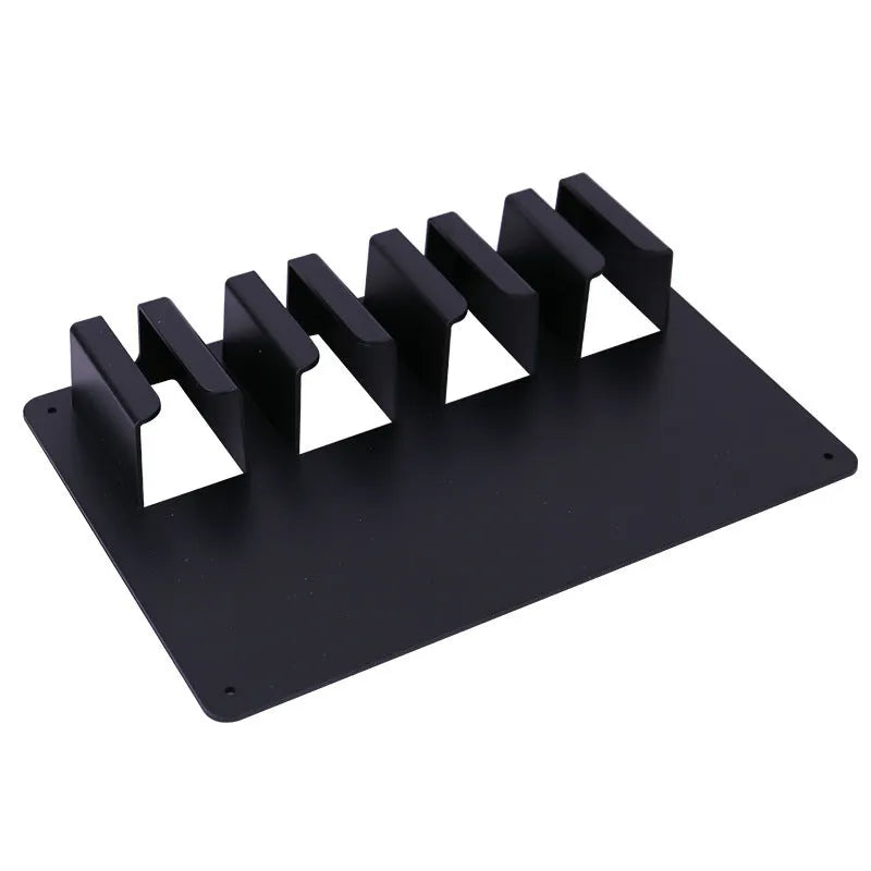 Black plastic wall-mounted rack holding four hair clippers