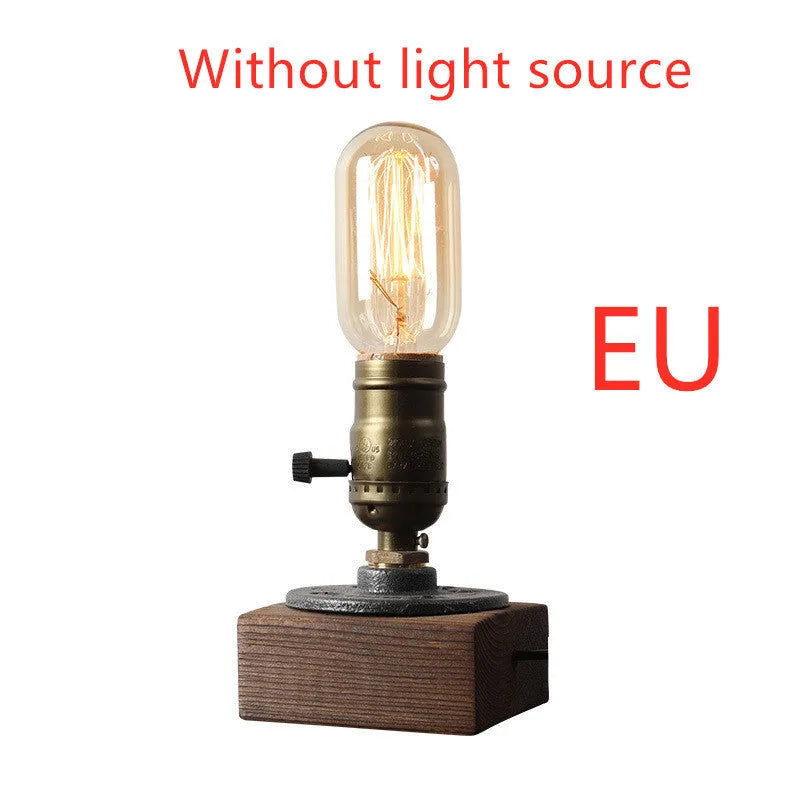Compact wooden and iron water pipe table lamp on a table surface