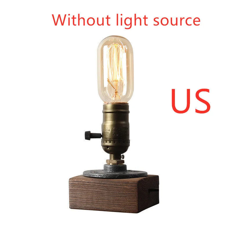 Compact wooden and iron water pipe table lamp on a table surface