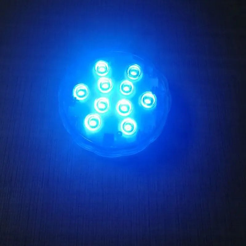 White waterproof LED disc light with remote control for pools and gardens.