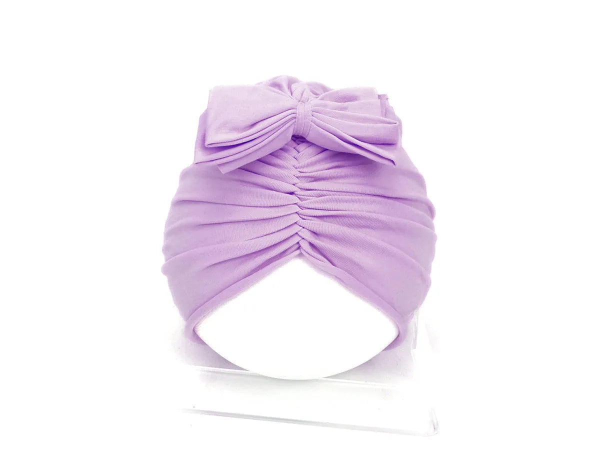 Soft acrylic knitted baby hat in a solid colour, shown on a mannequin head.