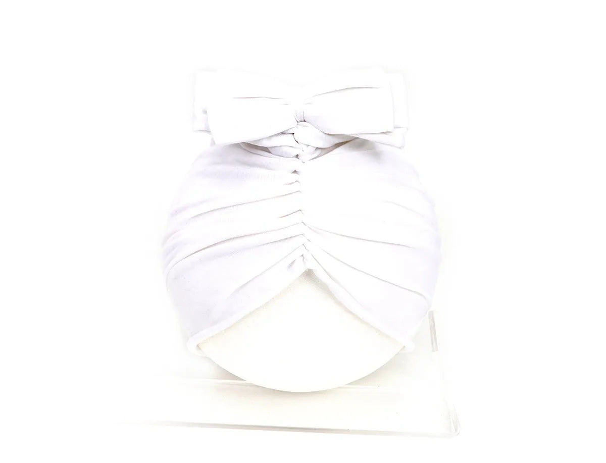 Soft acrylic knitted baby hat in a solid colour, shown on a mannequin head.