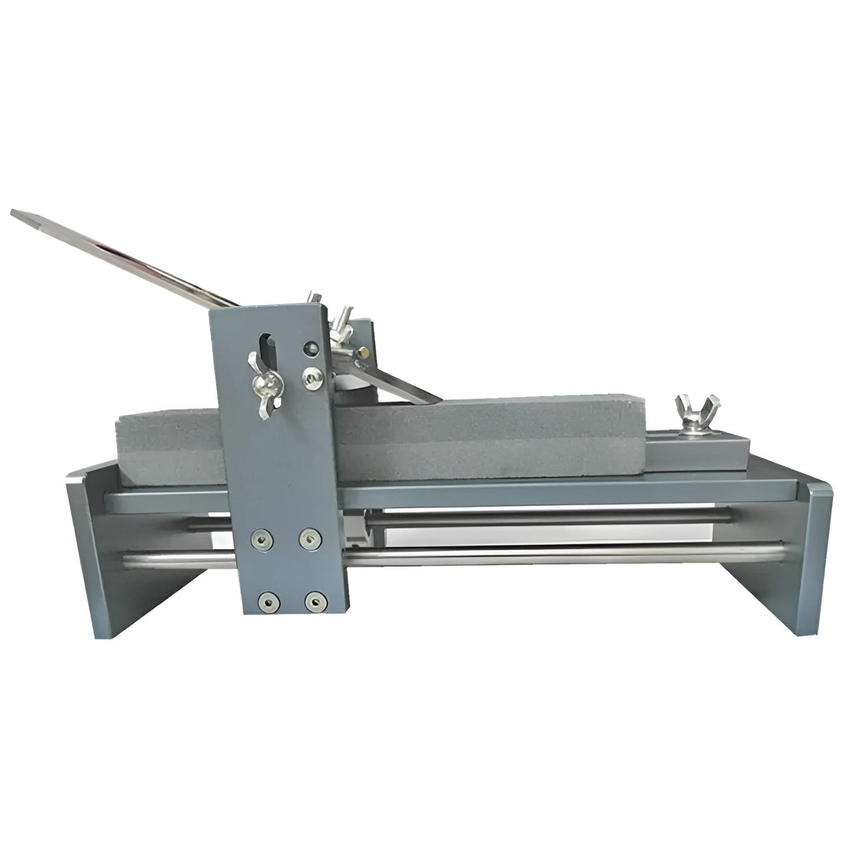 Aluminium alloy fixed angle sharpening tool for woodworking chisels and carving knives on a workbench.