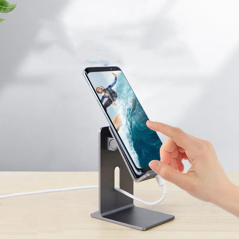 Dark space grey alloy mobile phone holder with lazy bracket on a desktop.