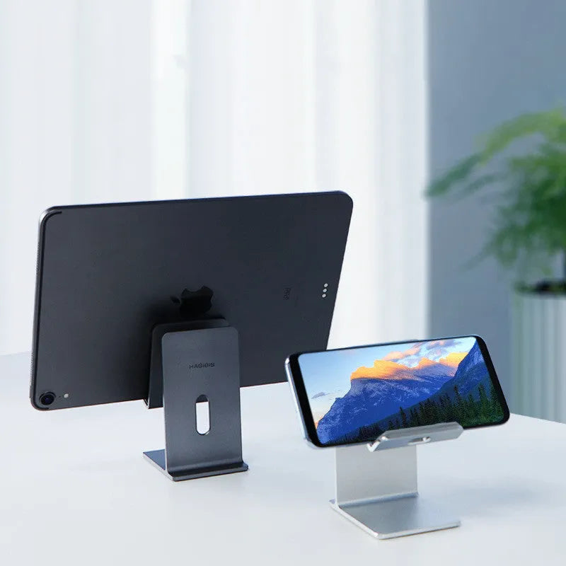 Dark space grey alloy mobile phone holder with lazy bracket on a desktop.
