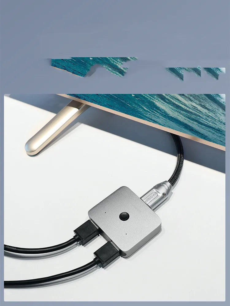 Grey HDMI switcher with one input and two output ports for 4K video sharing between displays