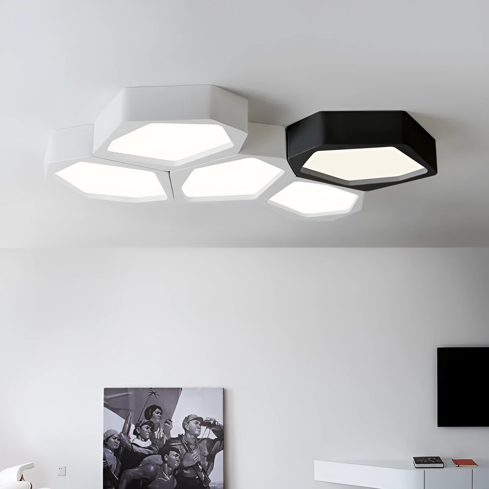 Geometric shaped iron LED light with remote control on a side table.