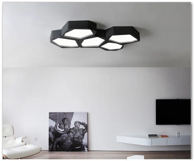 Geometric shaped iron LED light with remote control on a side table.