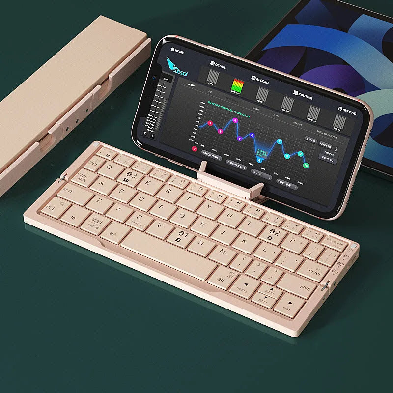 Silver white folding Bluetooth keyboard open with smartphone propped on integrated stand