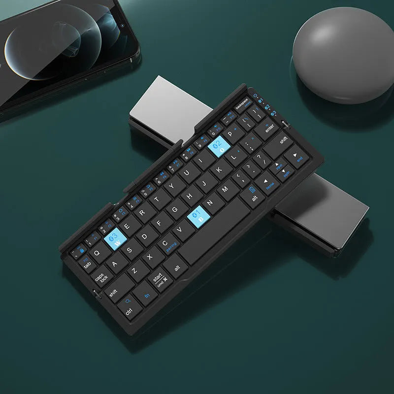 Silver white folding Bluetooth keyboard open with smartphone propped on integrated stand