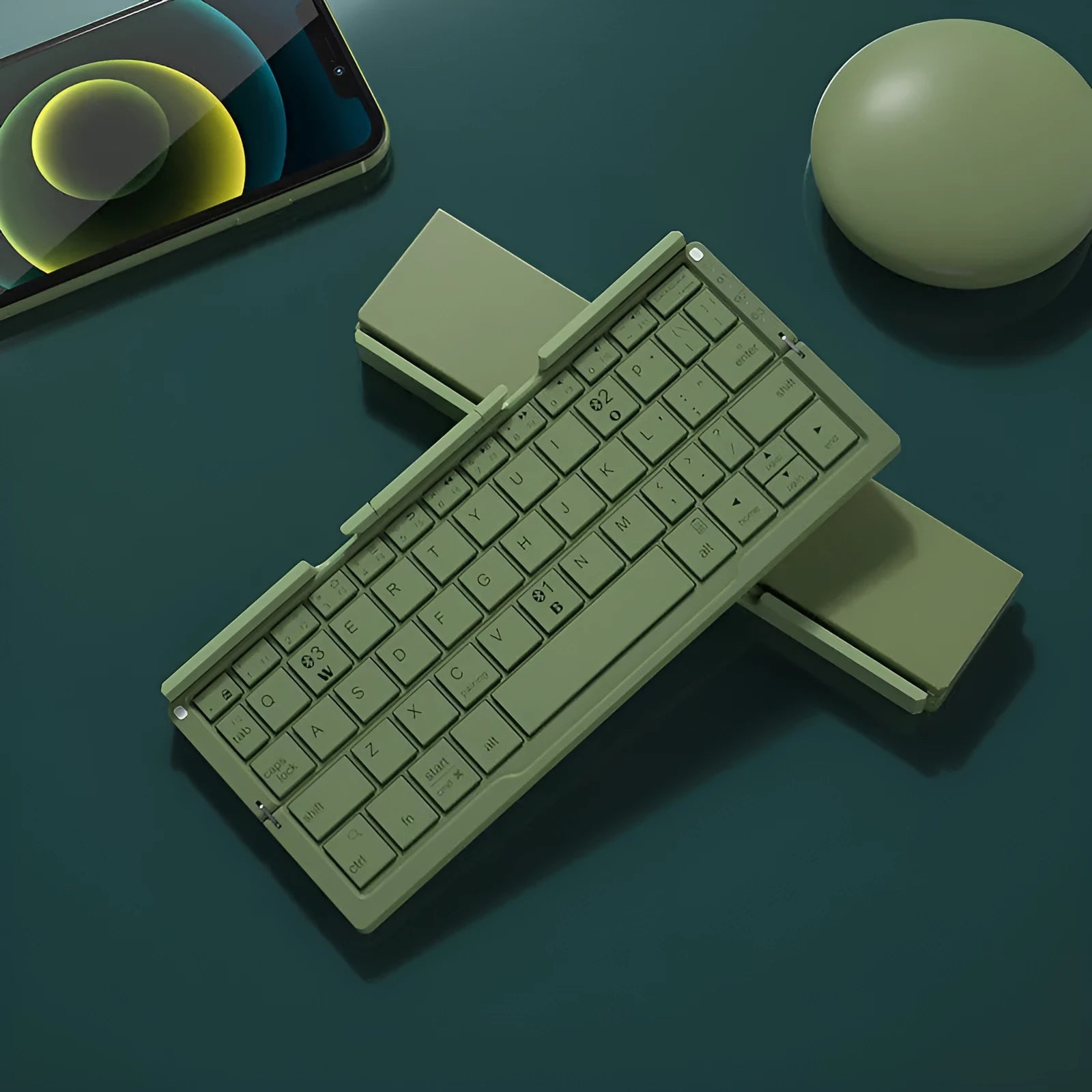 Silver white folding Bluetooth keyboard open with smartphone propped on integrated stand