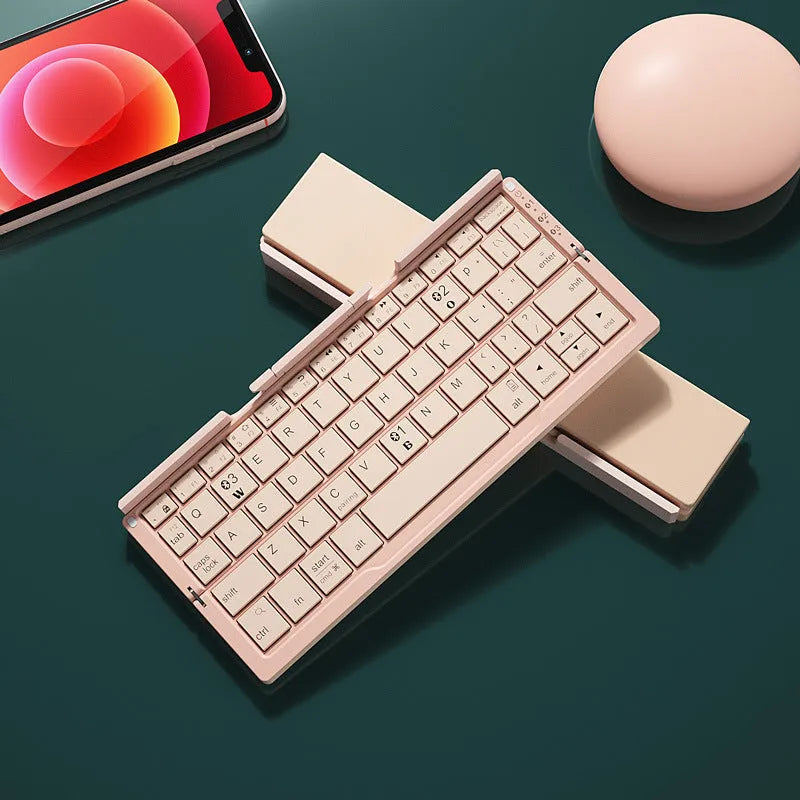 Silver white folding Bluetooth keyboard open with smartphone propped on integrated stand
