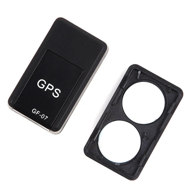 Small black plastic magnetic GPS tracker device with USB charging cable.