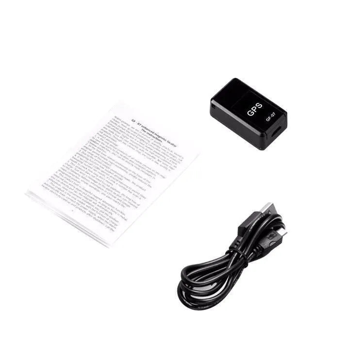 Small black plastic magnetic GPS tracker device with USB charging cable.