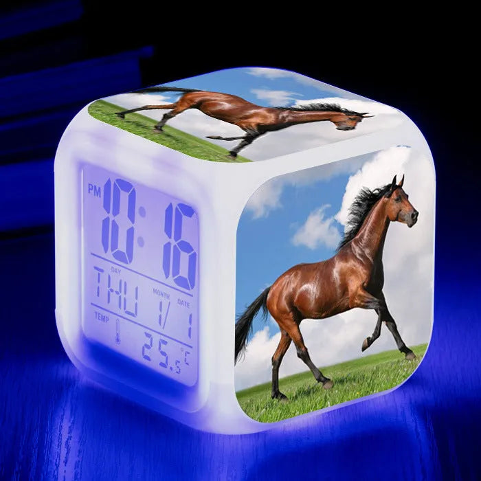 Small square LED digital alarm clock showing time and temperature on a plexiglass dial