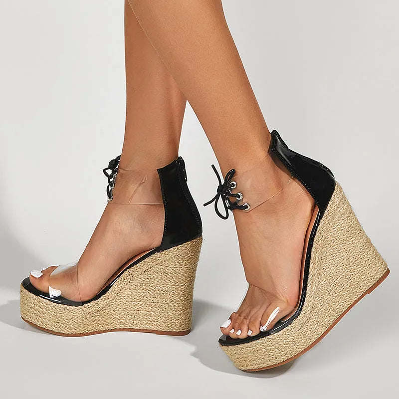 Black women's wedge sandals with hemp rope detail on high platform heel and front tie strap.