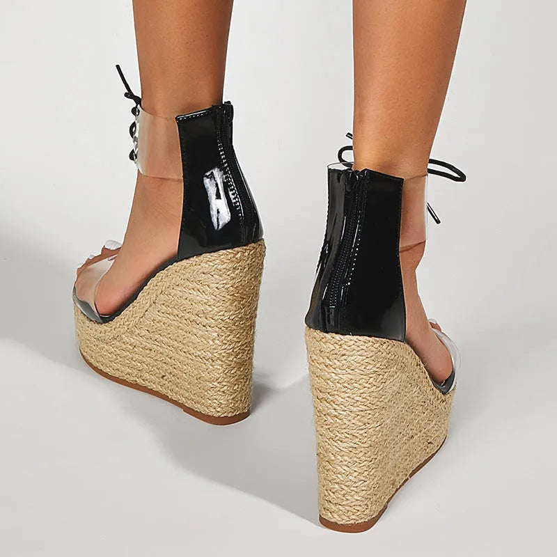 Black women's wedge sandals with hemp rope detail on high platform heel and front tie strap.