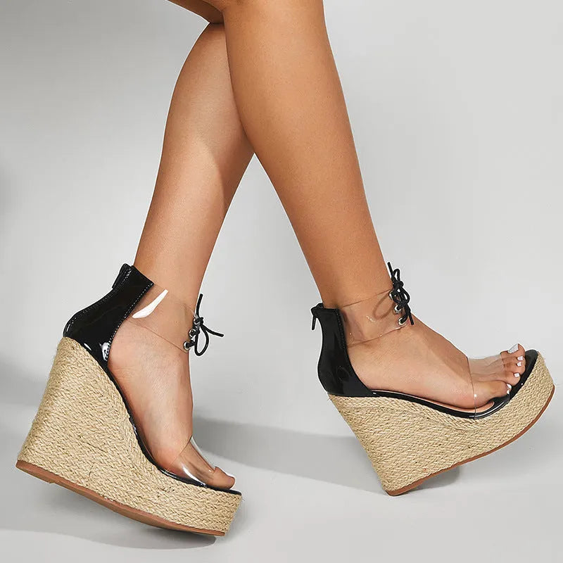 Black women's wedge sandals with hemp rope detail on high platform heel and front tie strap.