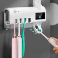 Black wall-mounted toothbrush steriliser with UV light and automatic toothpaste squeezer