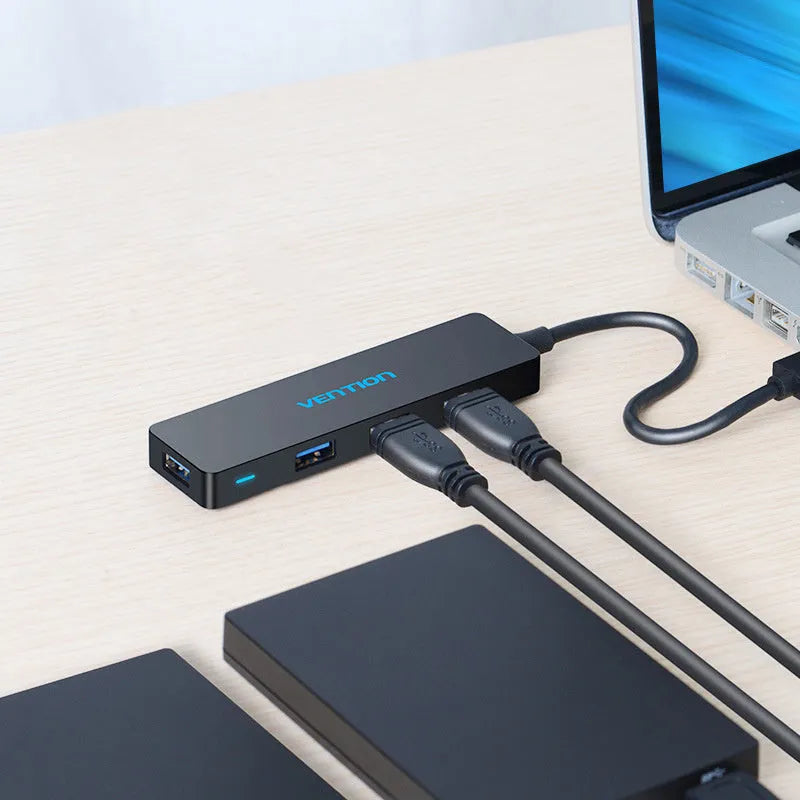Black four-port USB 3.0 hub with short cable and nickel-plated connectors