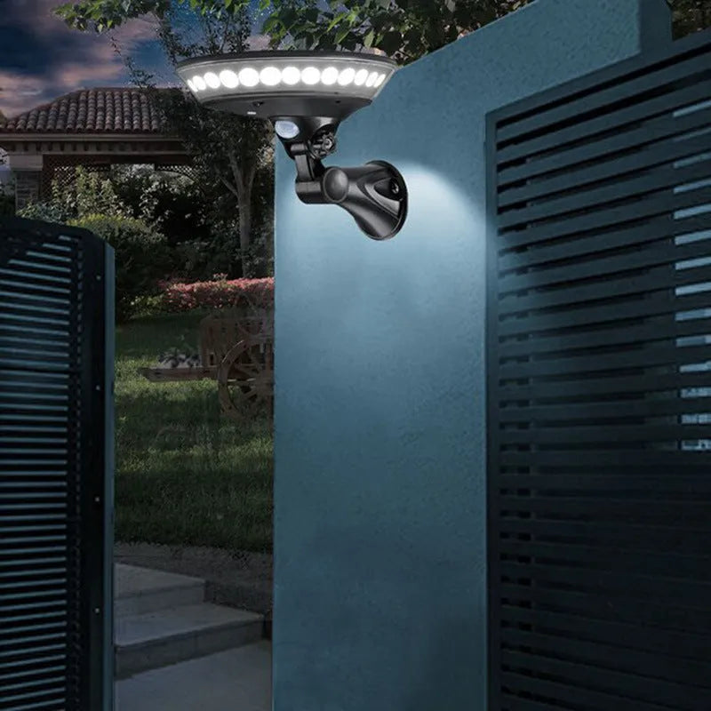 White 360-degree solar-powered outdoor light with motion sensor mounted on a wall.